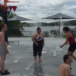 Group of teens playing outside at a fountain park