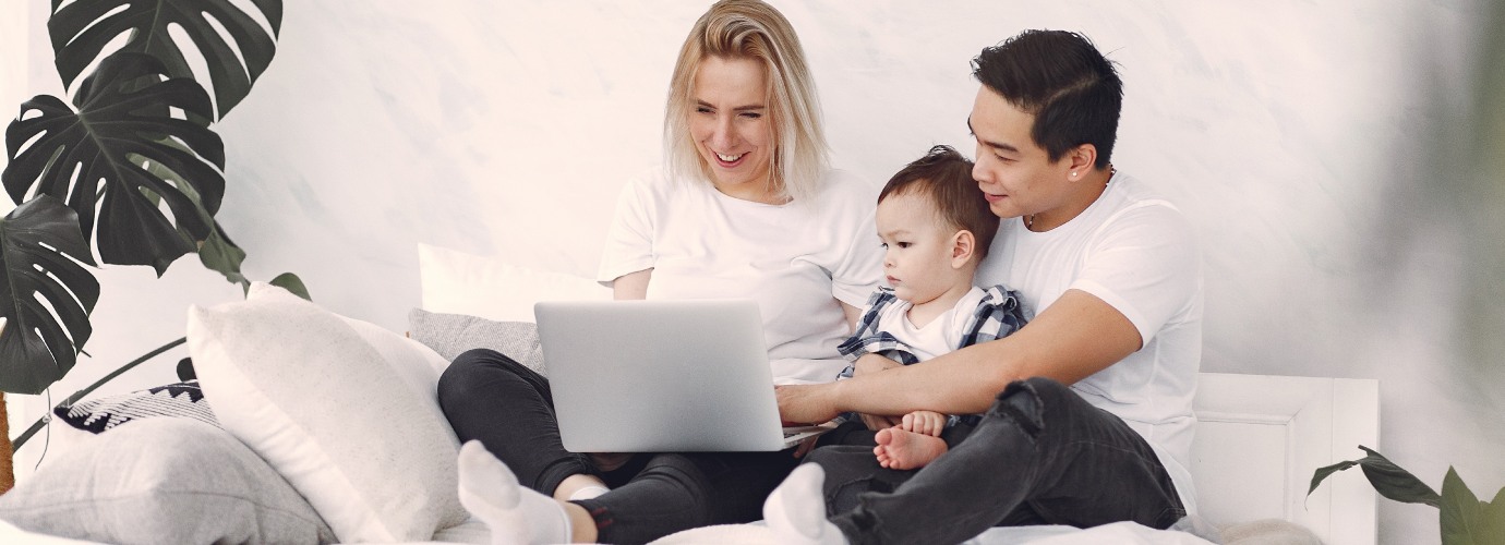 Family using laptop together, researching about YMCA in Central Massachusetts