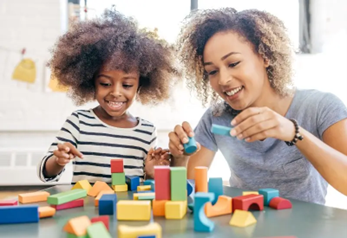 Toddler and mother playing with building blocks