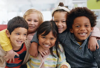 Group of diverse kids having a group hug