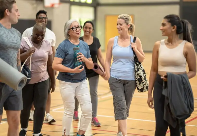 Group of diverse adults conversating after group exercise class