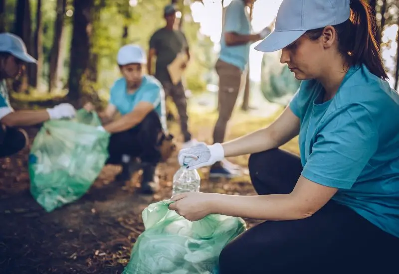 Group of people cleaning up a public park together