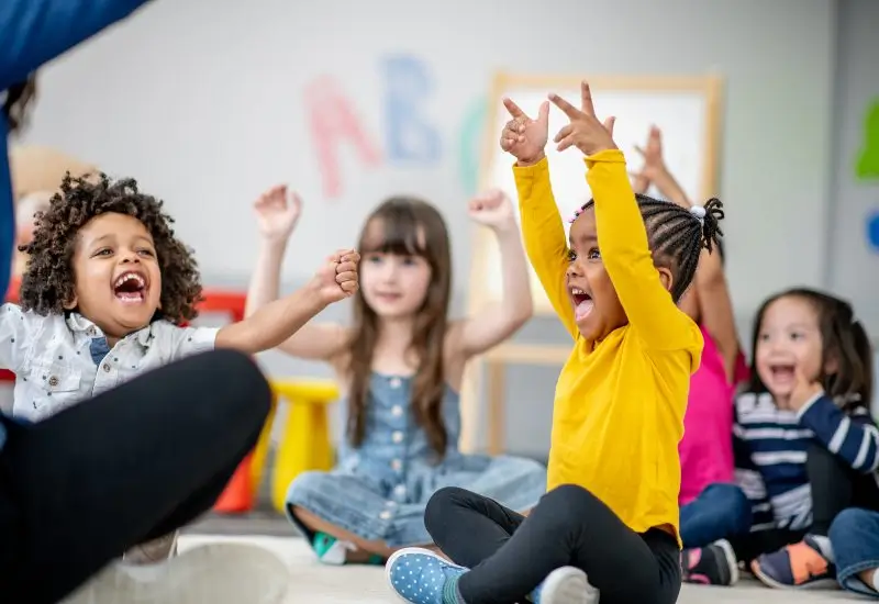 Group of children sitting on the floor of their classroom