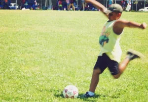 Young boy kicking a soccer ball