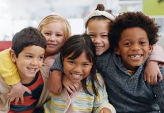 Group of kids from diverse cultures posing for a picture