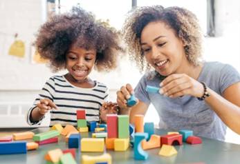 A child and mother playing with building blocks