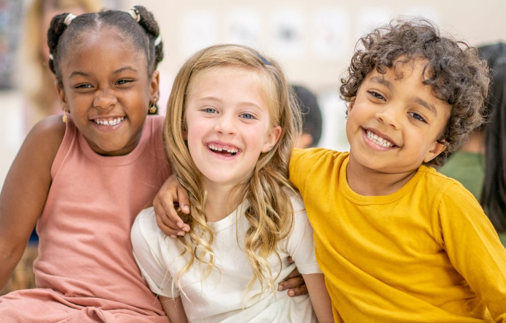 Group of smiling kids in a group hug