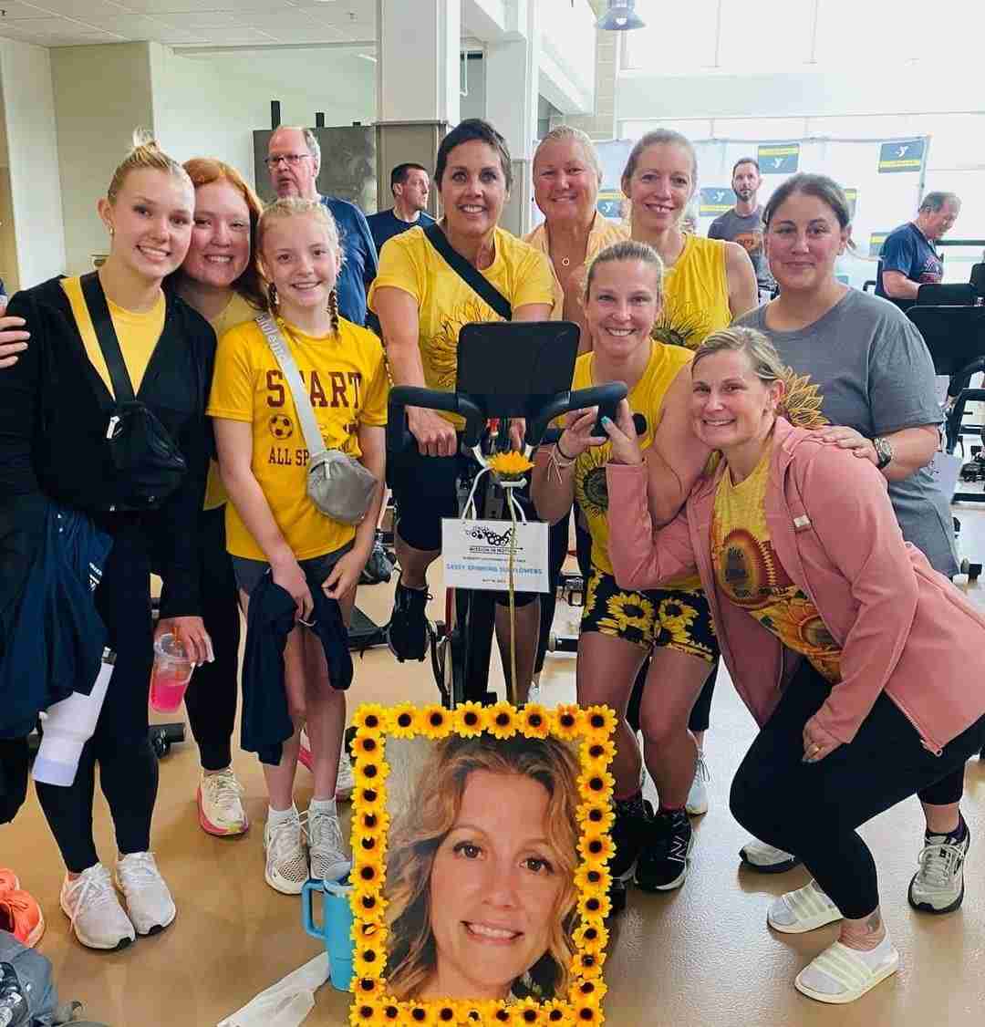 Group of people using a treadmill while posing for a picture at a gym in Central Massachusetts