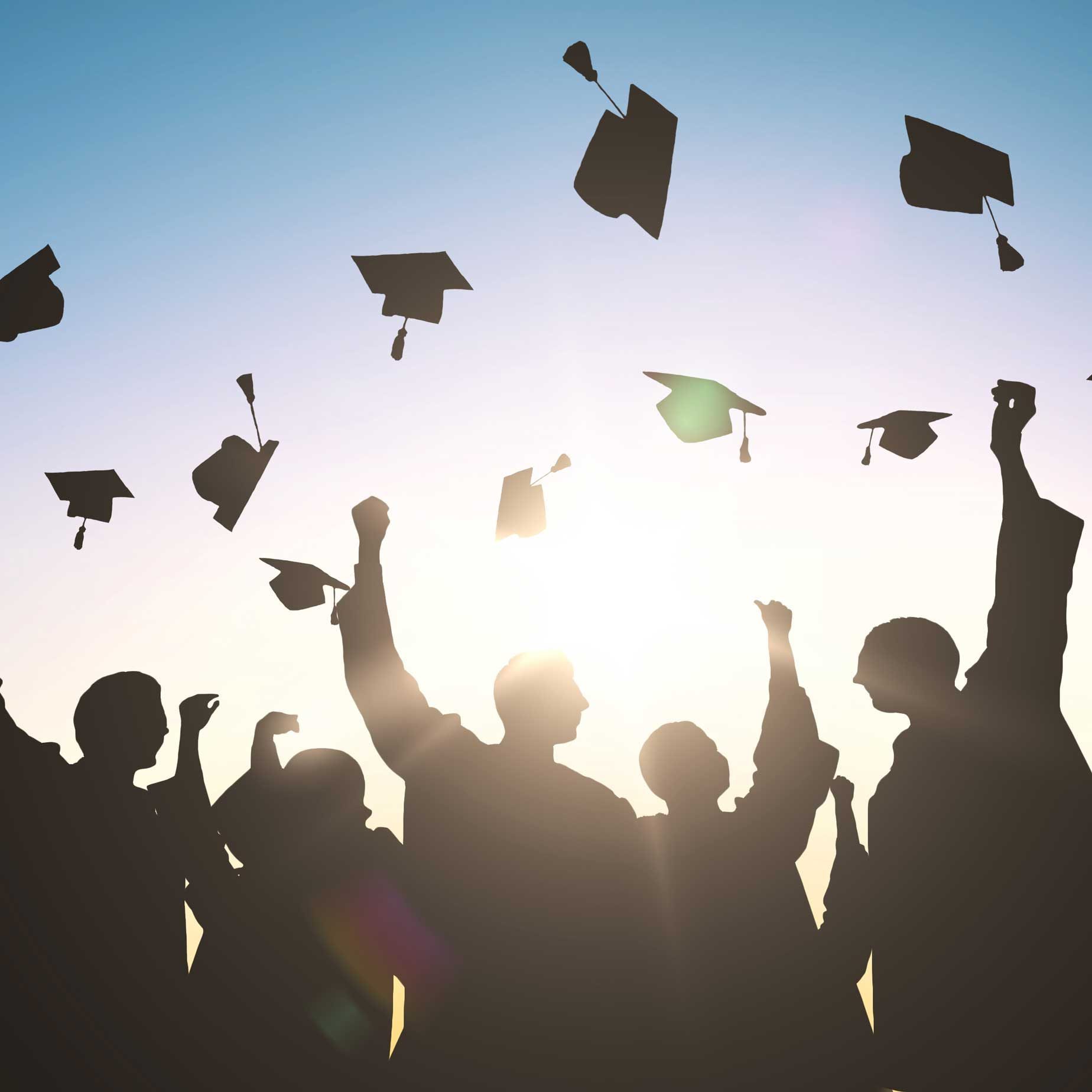 A group of students threw their graduation caps up in the air